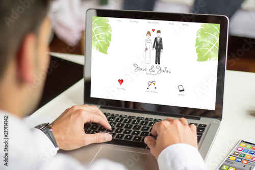 businessman browsing wedding website with computer