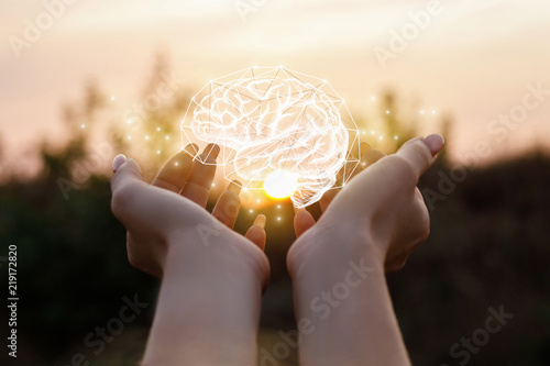 Female hand shows the brain .