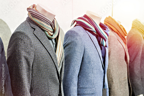Men's tweed sport coats with scarves in clothing store