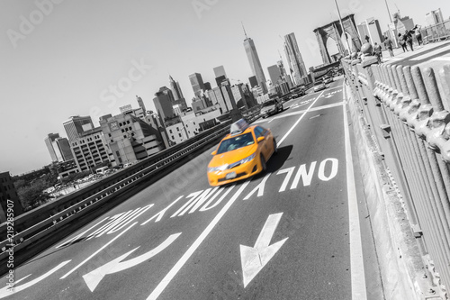 Yellow taxi car on Brooklyn bridge New York city NYC