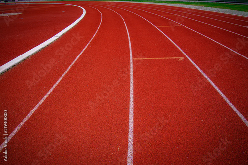 Red running track in the stadium.white line and Green lawn