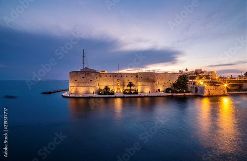 Night landscape of Aragonese Castle on seafront in Taranto. Italy amazing sunset