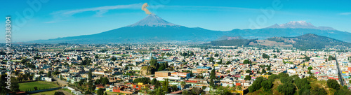 Eruption of Popocatepetl Volcano over the town of Puebla, Mexico, panoramic view