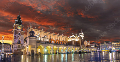 Cloth Hall Sukiennice building and main square of the old town illuminated at night on main square of Krakow city, Poland with a beautiful lights at sunset. Rynek glowny