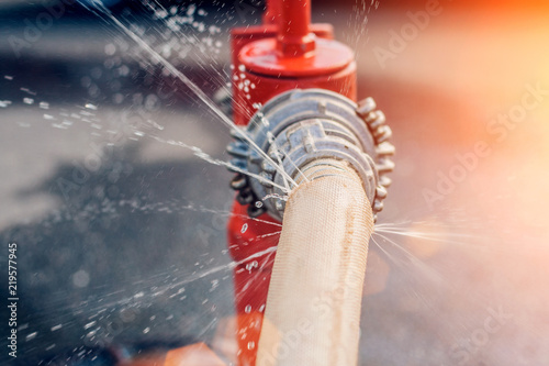 The flow of water and puddles from an open fire hydrant