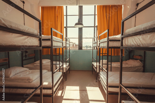 Window in bedroom of a youth hostel with clean beds for relaxing tourists and students