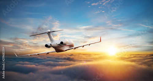 Private jet plane flying above clouds