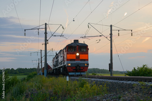 freight train is moving by rail at sunset of the day