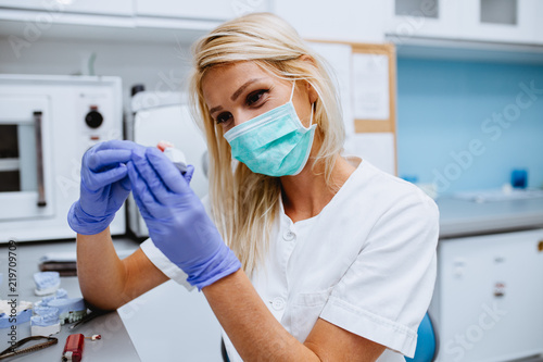 Dental technician making dentures. Dental prosthesis, prosthetics work.