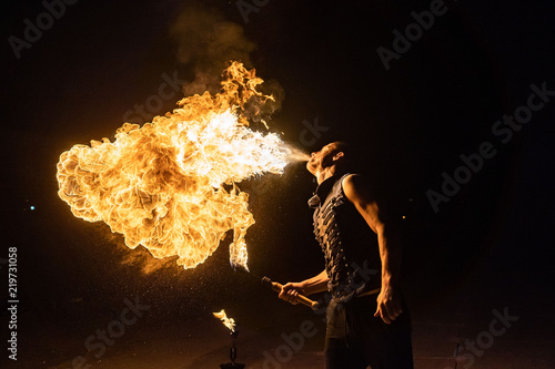 Fire show artist breathe fire in the dark