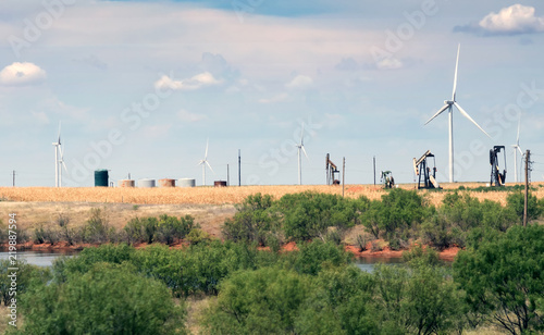 Typical landscape of Texas: endless fields, wind generators, oil pumps, rare green bushes