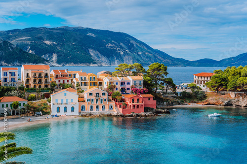 Beautiful panoramic view of Assos village with vivid colorful houses near blue turquoise colored and transparent bay lagoon. Kefalonia, Greece