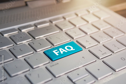 Keyboard with faq button .. Color button on the gray silver keyboard of modern ultrabook. caption on the button