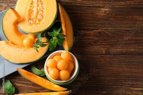 Composition with tasty melon on wooden table