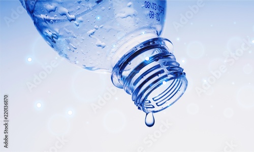 Water Drop Pouring out of Plastic Bottle on the Blue Background