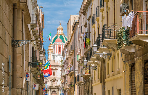 Scenic sight in Trapani with the Church of Saint Francis of Assisi in the background. Sicily, Italy.