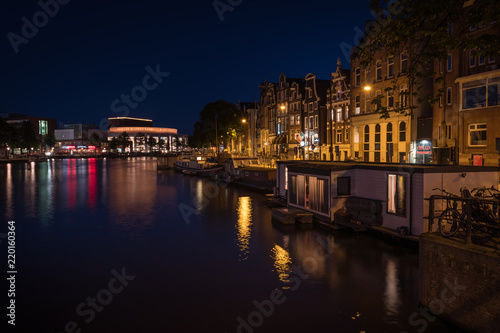 Reflection of the illuminated city of Amsterdam at night , Amsterdam, Netherlands.