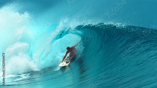 CLOSE UP: Professional surfboarder finishes riding another epic tube wave.