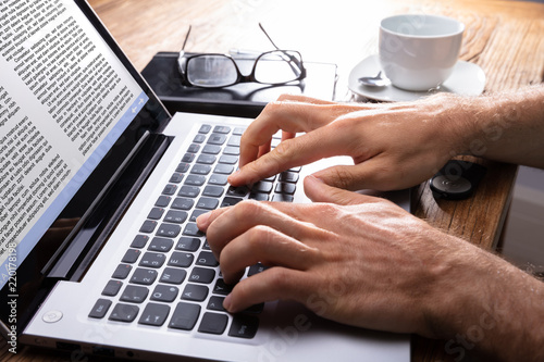 Close-up Of A Person Typing On Laptop