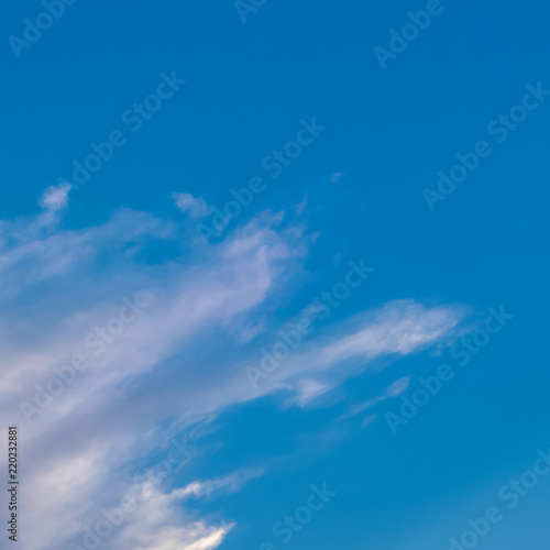 White clouds on clear blue sky