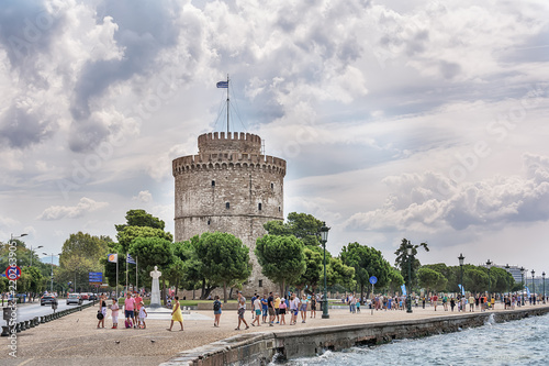 Thessaloniki, Greece - August 16, 2018: White Tower behind admiral Votsis statue, Thessaloniki, Greece. Nikolaos Votsis was a Greek naval officer who distinguished himself during the Balkan Wars.