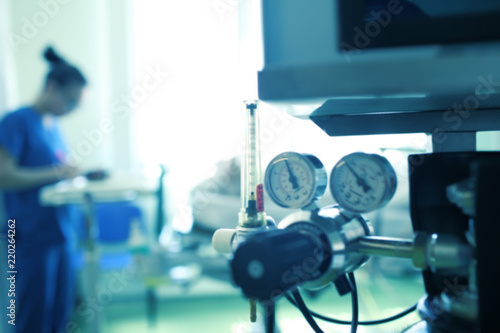 Blurred silhouette of a female medical worker on the background of gas equipment, unfocused background