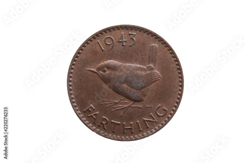 Old pre decimal 1943 George VI farthing coin of England UK reverse Wren cut out and isolated on a white background