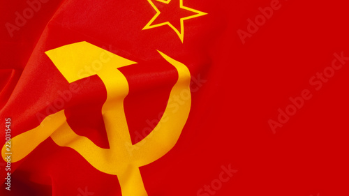 Communism and Marxism concept with close up on the hammer and sickle from the flag of the old Union of Soviet Socialist Republics (USSR or Soviet Union) with a wave and copy space