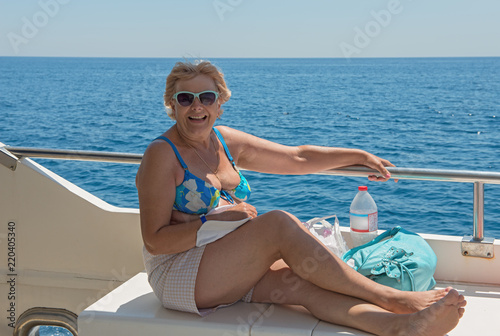 Women on the deck of trimaran that is going near Costa Brava coastline.