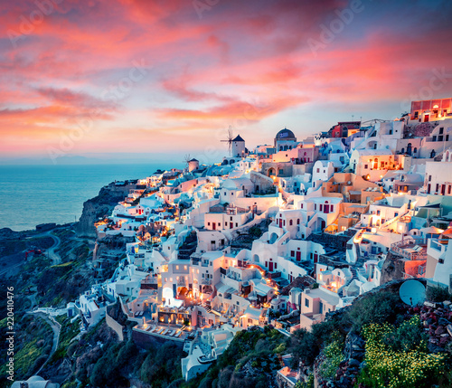 Impressive evening view of Santorini island. Picturesque spring sunset on the famous Greek resort Oia, Greece, Europe. Traveling concept background. Artistic style post processed photo.