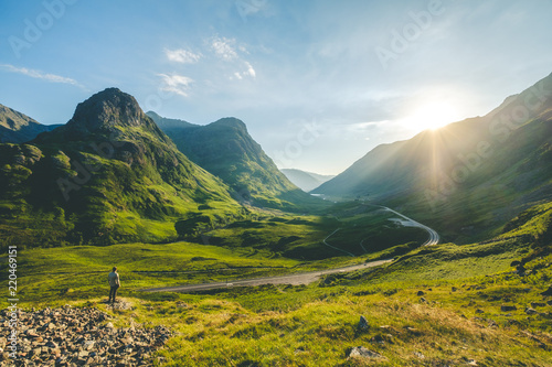 A man looking standing face to the sun at Glencoe
