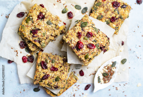 Granola Bars, Superfood Homemade Snack, Healthy Bars with Cranberry, Pumpkin Seed, Oats, Chia and Flax Seed on bright background