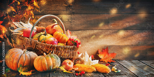 Thanksgiving pumpkins with fruits and falling leaves