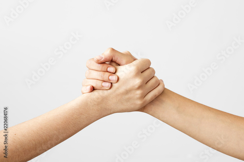 Two hands holding each other strongly