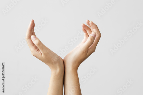Cupped hands on gray background