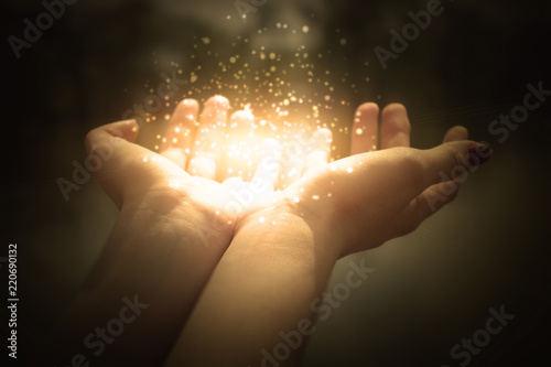 magic particles on the palms of a woman, a stream of magical energy emanating from female hands
