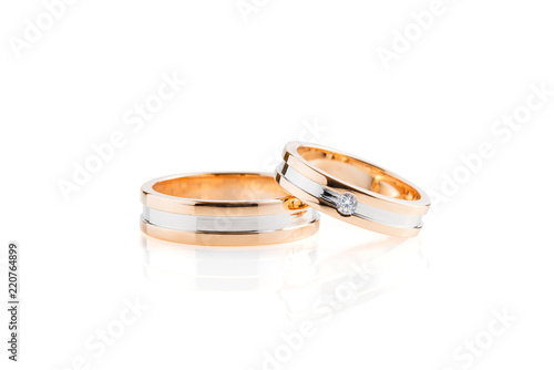 Rose gold and white gold wedding rings isolated on white background