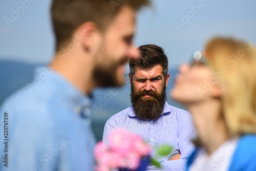 Lovers meeting outdoor flirt romance relations. Couple romantic date lover present bouquet flowers. Couple in love dating while jealous husband fixedly watching on background. Unrequited love concept