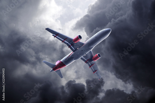 Passenger airplane flying on stormy sky with dark clouds and lightnings.