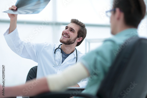 orthopedist examining a radiograph of a patient