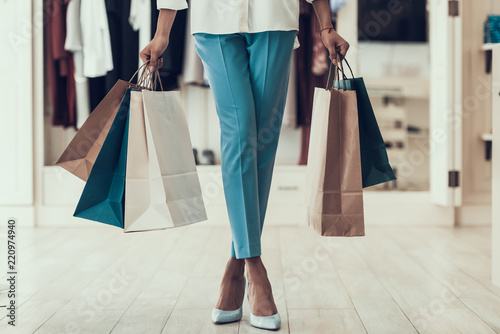 Closeup Young Girl holding Shopping Bags in Store