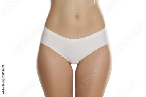 front view of female hips with white panties on white background