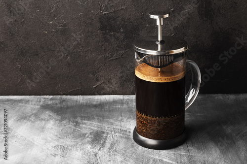 Coffee in french press on dark background. Copy space. Food background