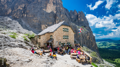 RIFUGIO VICENZA, SASSOLUNGO MASSIF, ITALY, JULY 1, 2018: Mountaineering people resting at Vicenza chalet in Dolomites mountains.
