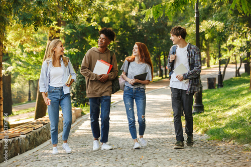 Group of happy students walking at the campus