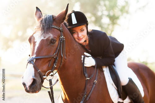 A beautiful girl rider drives a horse. Horse theme