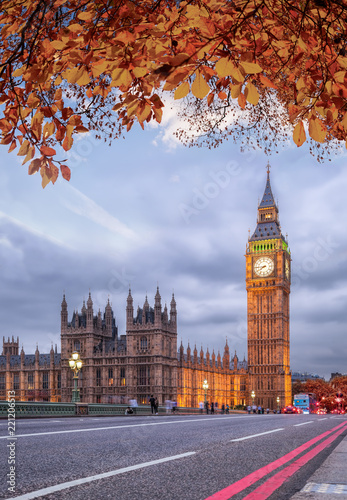 Buses with autumn leaves against Big Ben in London, England, UK