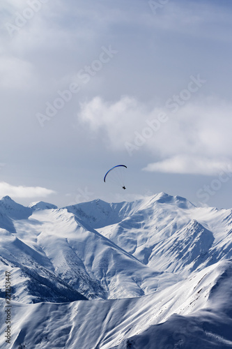 Sky gliding in winter mountains