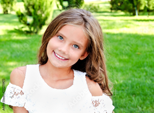 Portrait of adorable smiling little girl child outdoors