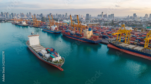 Container ship from sea port working for delivery containers shipment and container warehouse background. Suitable use for transport or import export to global logistics concept.